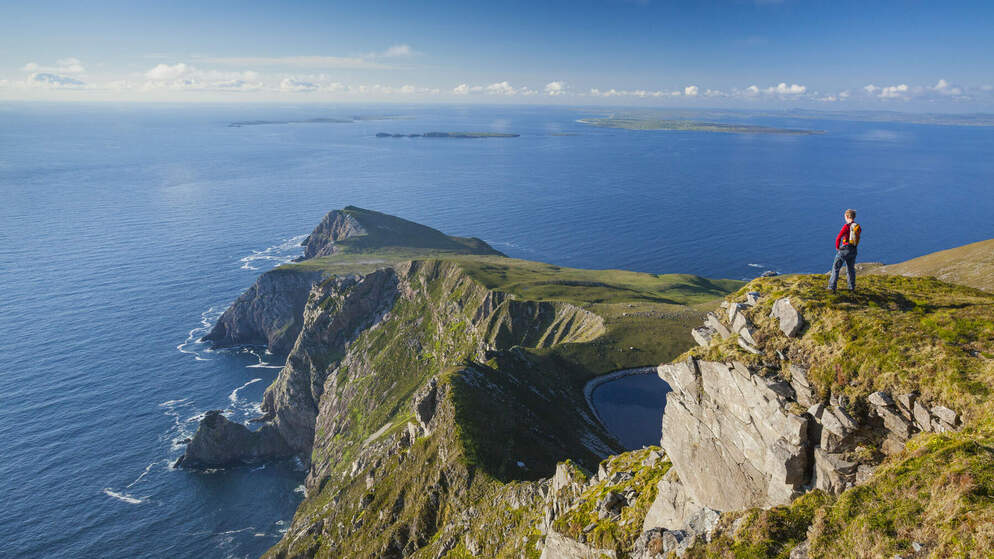 Walker looking towards Saddle Head from Croaghaun Achill Island Co Mayowebsize2500x1200px 1