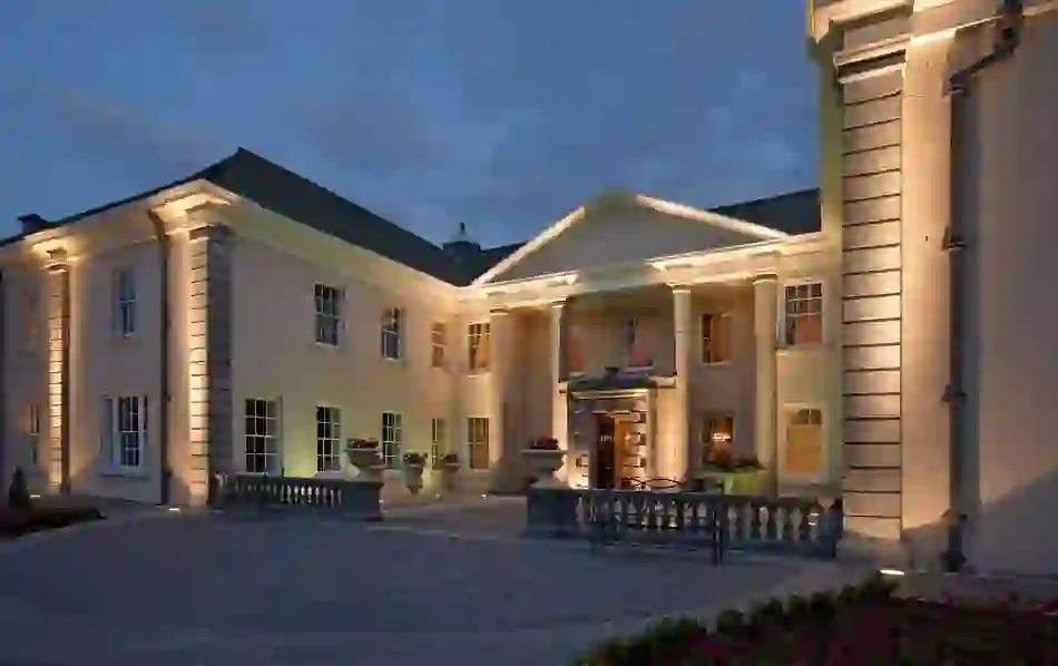 Georgian-style hotel entrance lit at dusk at Castlemartyr Resort in County Cork.
