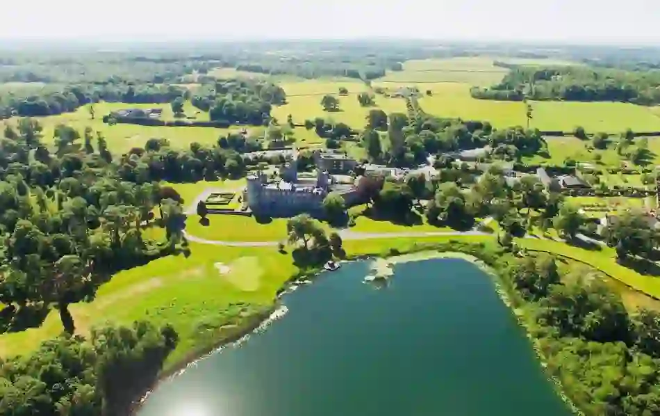 Aerial view of lakeside Dromoland Castle Hotel offering dog-friendly stays in County Clare.