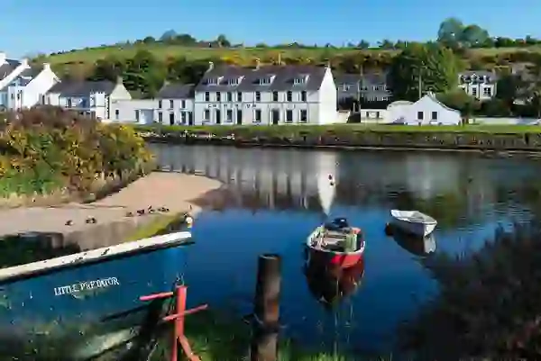 Fishing boats moored on the river at Cushendun village, County Antrim.