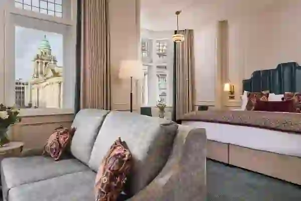 Elegant hotel room at The Bedford Hotel Belfast with Belfast City Hall visible through the window.