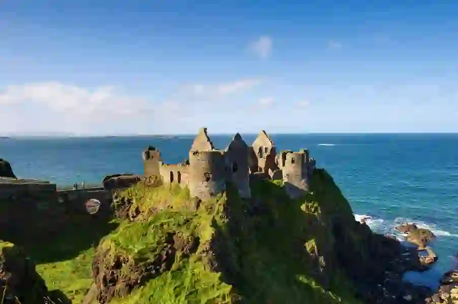 Ruins of Dunluce Castle perched on cliffs above the Atlantic Ocean in County Antrim.