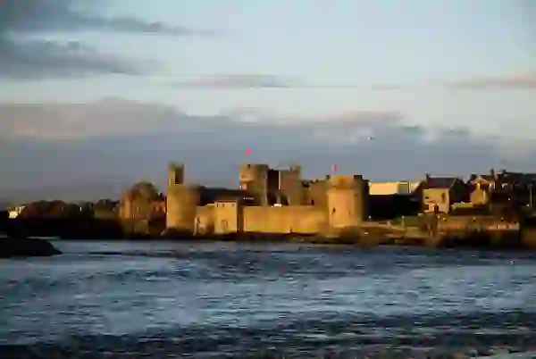 King John's Castle viewed across the River Shannon in Limerick City at sunset.