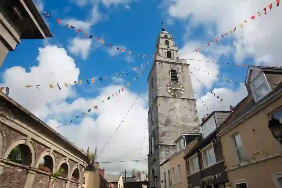 Shandon Bells Tower with colourful bunting under a blue sky in Cork city.