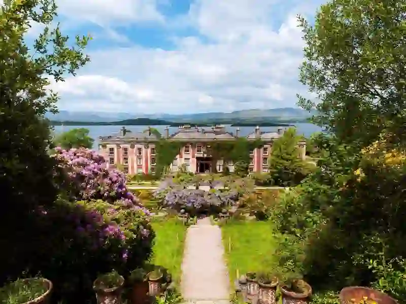 Grand ivy-covered Bantry House with formal gardens against a backdrop of sea and mountain views in Cork.