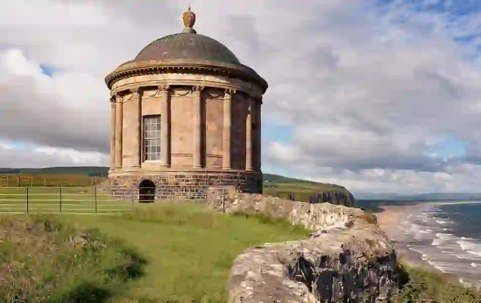 Mussenden Temple perched on a cliff edge in County Londonderry, overlooking the sweeping coastline and beach far below.