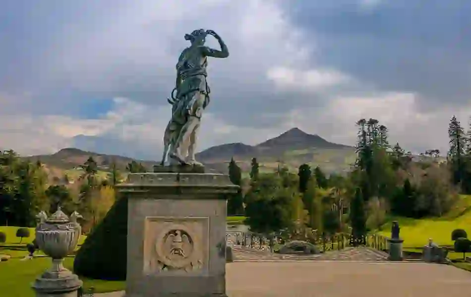 Statue of Diana the Huntress at Powerscourt Estate in County Wicklow, overlooking manicured gardens and Sugarloaf Mountain.