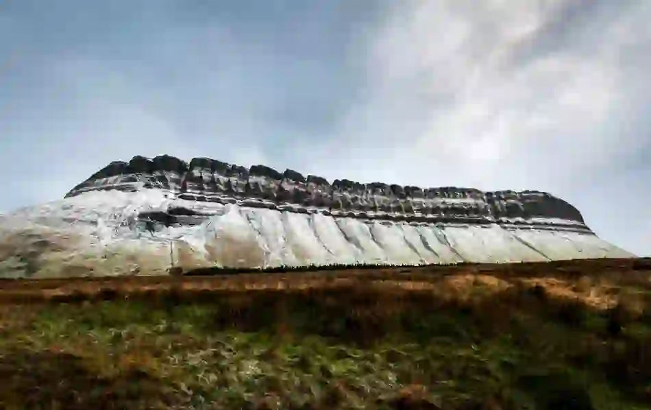Snow traces the iconic ridges of Ben Bulben in County Sligo under a wintry sky.