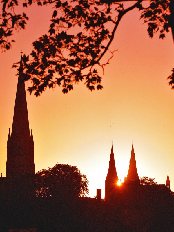 Silhouette of cathedral spires at sunset in Armagh, Northern Ireland.