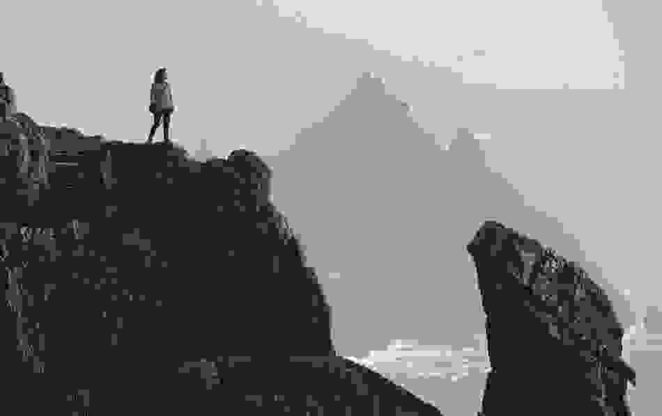 Visitor standing on the dramatic stone steps of Skellig Michael, County Kerry.