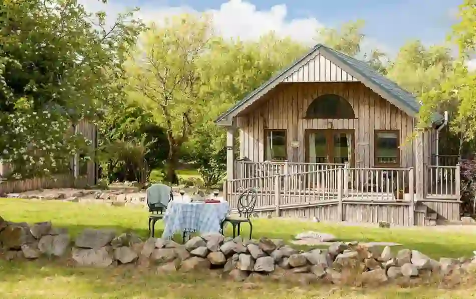 Cosy wooden eco-cabin with outdoor seating at Ard Nahoo, County Leitrim.