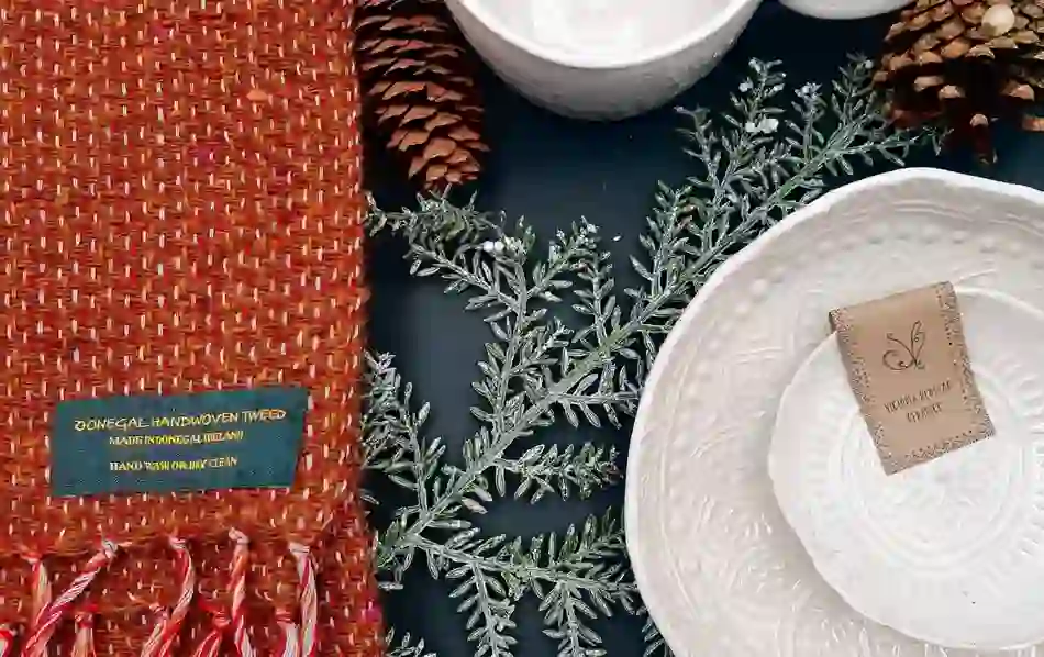 A display of handcrafted Donegal tweed, pine cones, and Victoria Benham ceramics celebrates Irish design and sustainability.