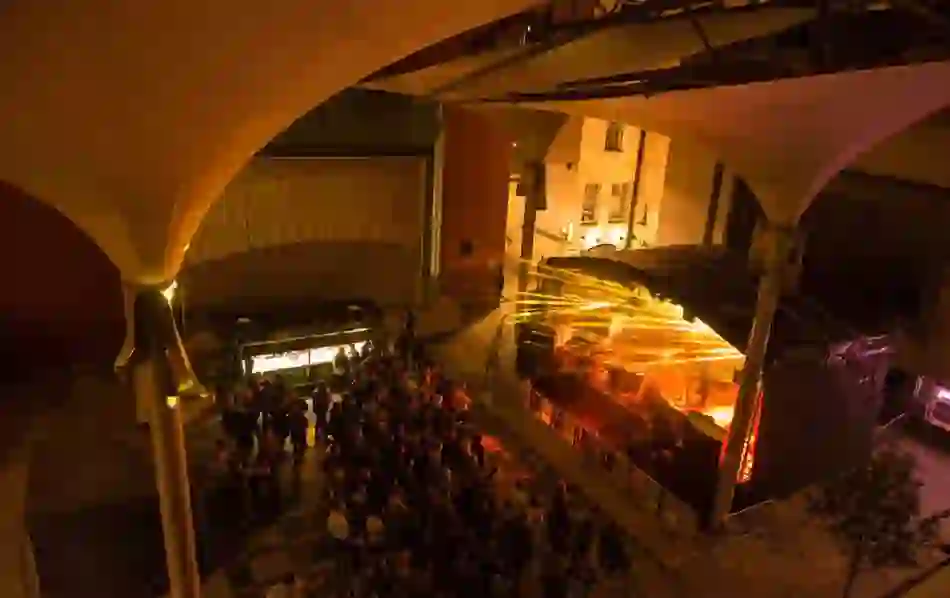 Crowd gathered at an outdoor music stage with dramatic lighting at Meeting House Square, Temple Bar.