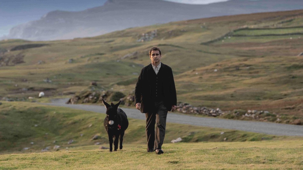 Colin Farrell walks a winding coastal road on Ireland’s Wild Atlantic Way in The Banshees of Inisherin.