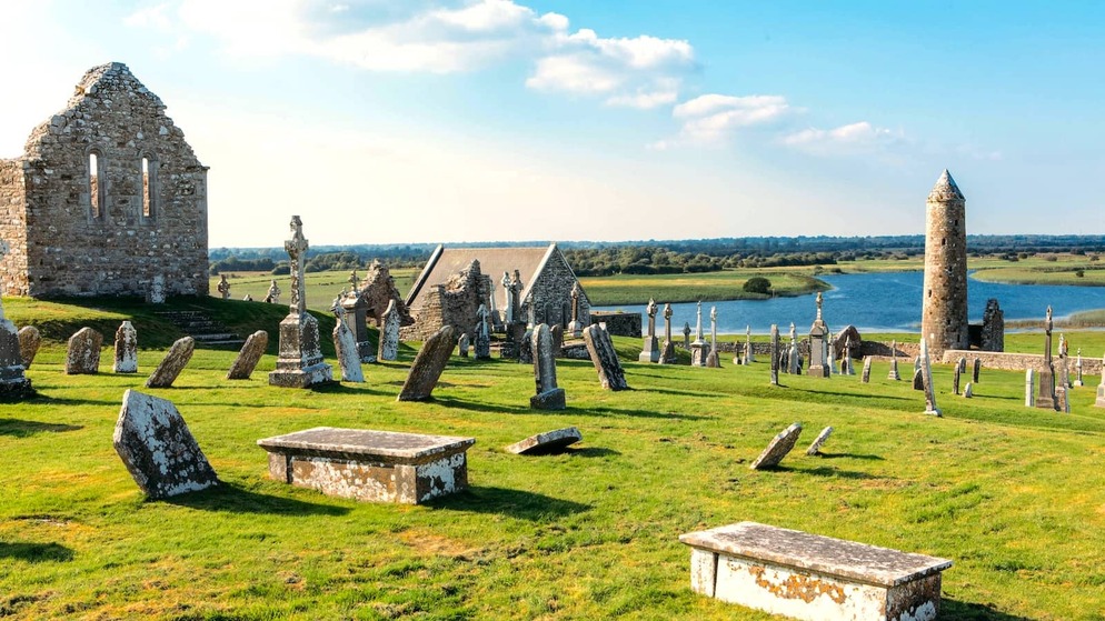 Gravestones and church ruins at Clonmacnoise overlooking the River Shannon in County Offaly.