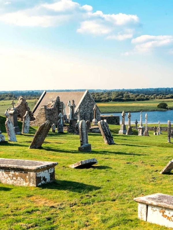 Gravestones and church ruins at Clonmacnoise overlooking the River Shannon in County Offaly.