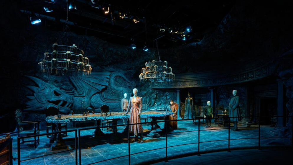 Great Hall set with a carved dragon wall, long table and hanging chandeliers at the Game of Thrones Studio Tour in Banbridge.