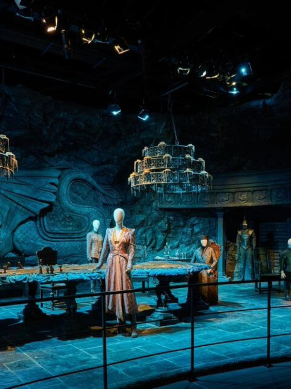 Great Hall set with a carved dragon wall, long table and hanging chandeliers at the Game of Thrones Studio Tour in Banbridge.