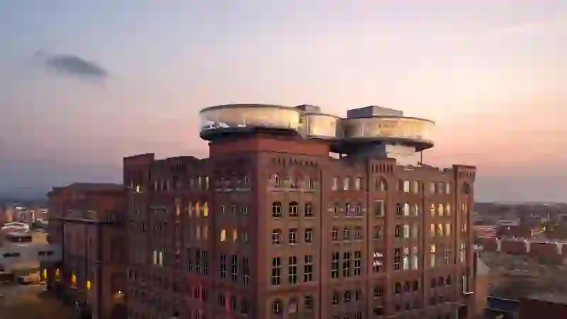 Exterior of the Guinness Storehouse in Dublin at sunset, with the glass-walled Gravity Bar on top.