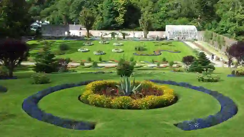 Formal walled garden at Kylemore Abbey with manicured lawns and mountain backdrop.