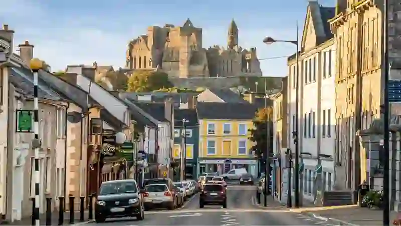 View down Cashel town street with the Rock of Cashel ruins on the hill in County Tipperary.
