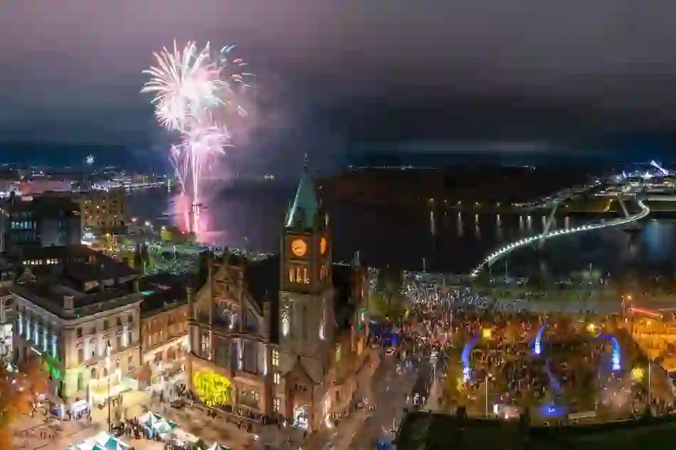 Fireworks over River Foyle and Peace Bridge during Derry Halloween celebrations.