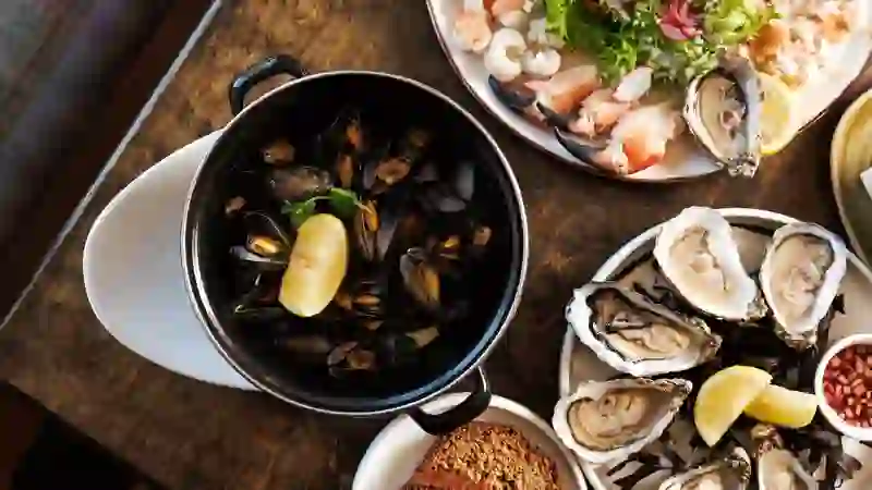 Fresh seafood spread at Monk's, County Clare, with oysters, mussels, crab and brown bread served on a rustic table.