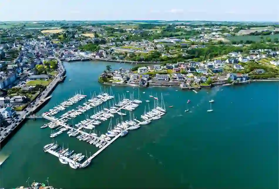 Aerial view of Kinsale Harbour and marina in County Cork, with yachts and colourful waterfront buildings.