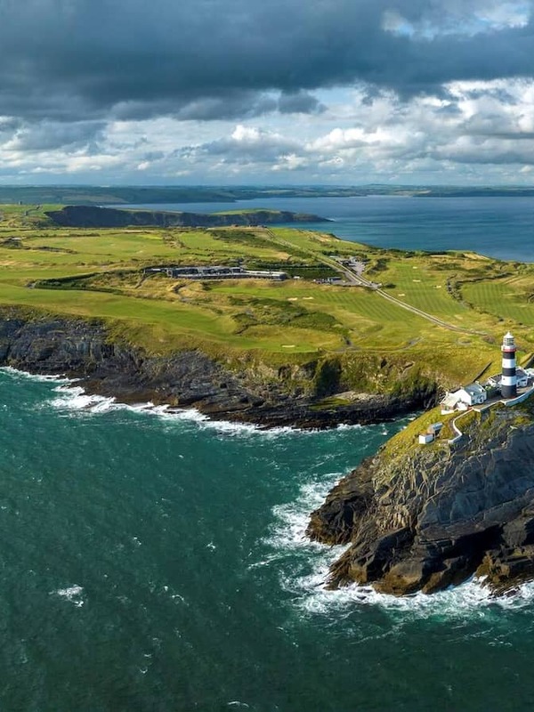 Aerial view of Old Head Golf Links in County Cork overlooking dramatic cliffs and the Atlantic Ocean.
