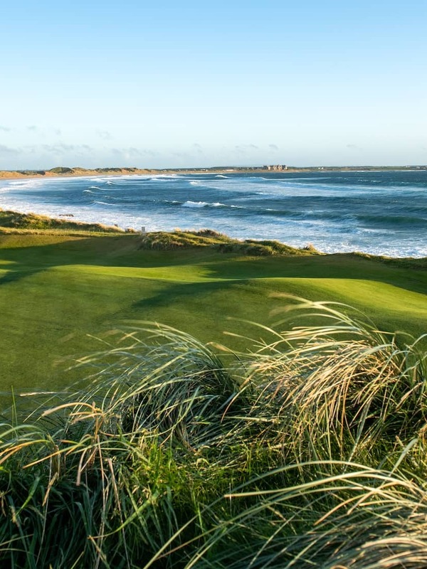 Green overlooking the Atlantic coastline at Doonbeg Golf Club in County Clare.