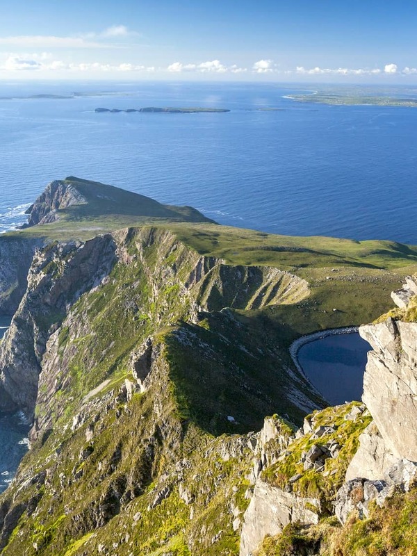 Walker overlooking the cliffs at Saddle Head on Achill Island, County Mayo.