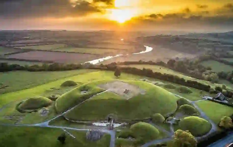 Drone view of Brú na Bóinne passage tombs in County Meath at sunrise, a UNESCO World Heritage Site.