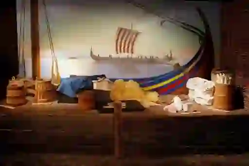 Exhibit of a Viking longship with colourful sail and tools at the Dublinia Viking Museum, Dublin.
