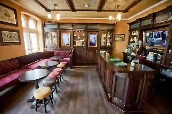 Interior of the Irish Whiskey Museum in Dublin featuring a traditional bar, vintage stools, and whiskey memorabilia.